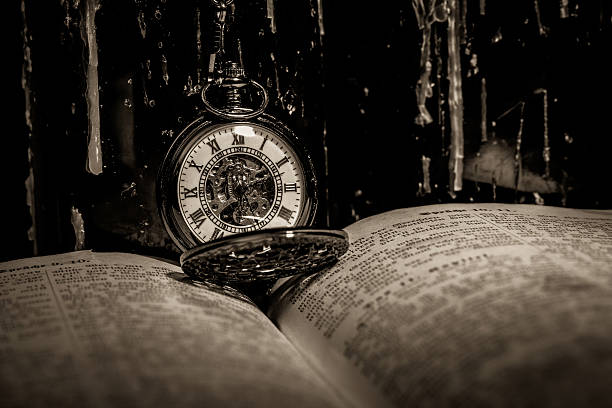 bible and steampunk clock stock photo