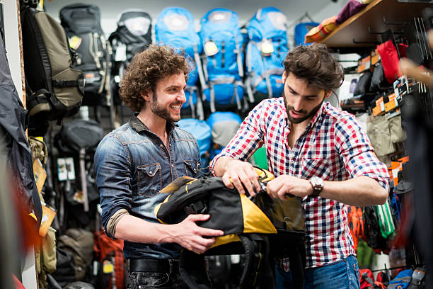 istock Men in sports store testing backpacks 520471911