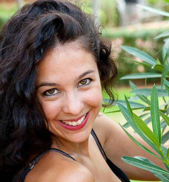 istock Beautiful woman in a park 520472897