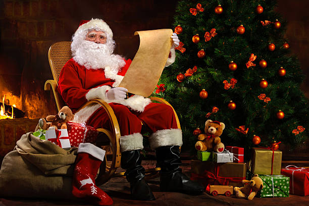 istock Santa Claus sitting in front of fireplace 520490432
