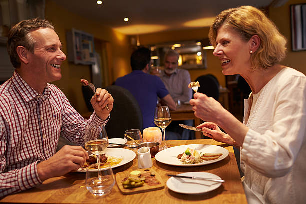 istock Senior couple having a meal together at a restaurant 520492856