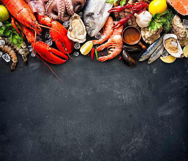 Shellfish plate of crustacean seafood Shellfish plate of crustacean seafood with fresh lobster, mussels, oysters as an ocean gourmet dinner background bivalve photos stock pictures, royalty-free photos & images