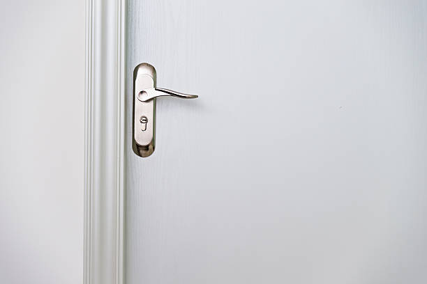 istock Close-up of white door with handle 520494040