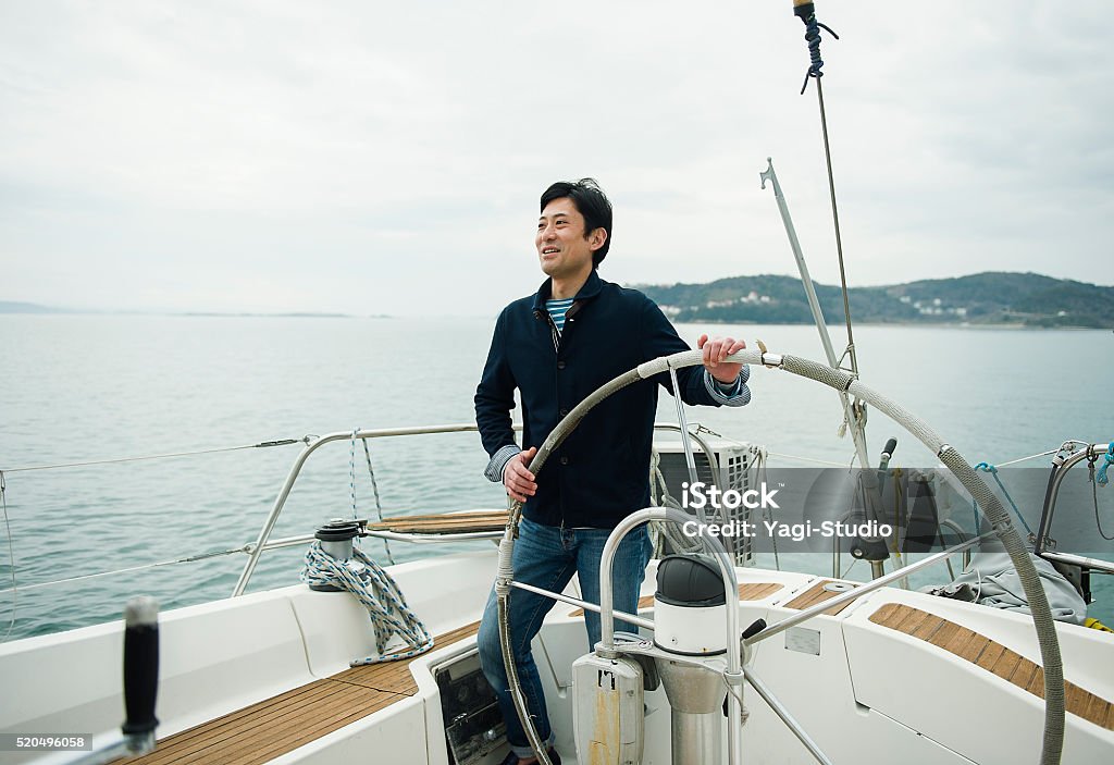 Mature man has been sailing the yacht Men working with a sail of the yacht Wealth Stock Photo