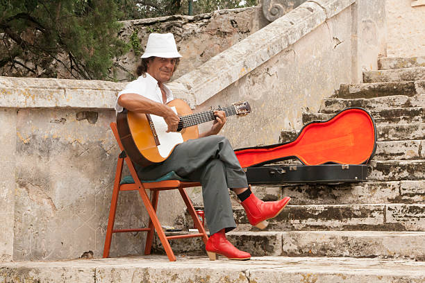Pollenca, Mallorca, Spain - September 6, 2015: Spanish street guitarist is playing for listeners on the street of Pollenca town on Mallorca island, Spain.