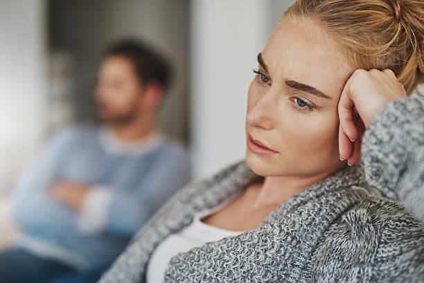 How do I get my marriage back on track? Cropped shot of an unhappy young couple after a fight at home sulking stock pictures, royalty-free photos & images
