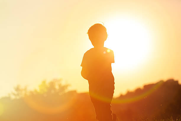 istock silhouette of little boy running at sunset 520498406