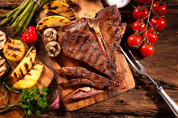 istock Beef steak with grilled vegetables on wood 520499456