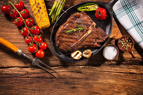 istock Beef steak with grilled vegetables on wood 520499836
