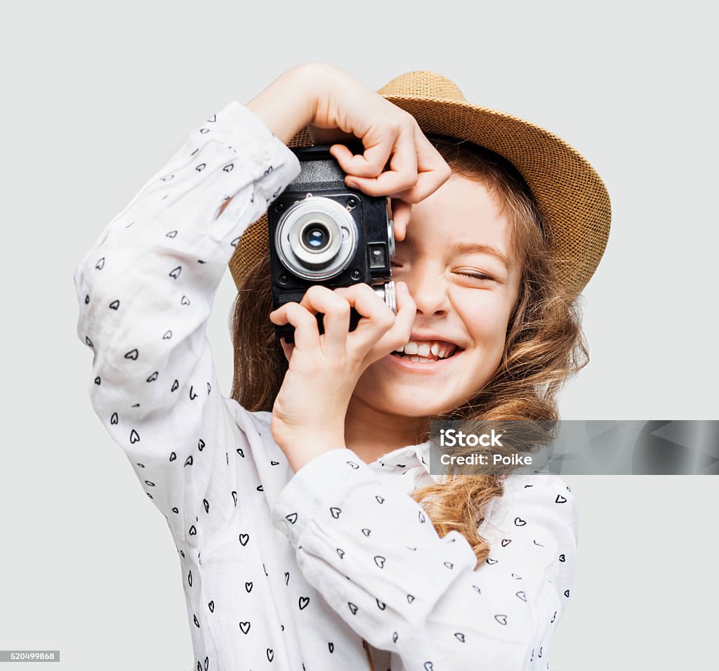 Young photographer looking at camera Funny little girl looking at camera Child Stock Photo