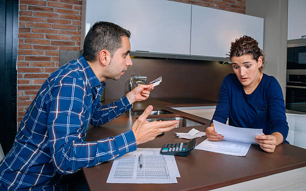 istock Angry young couple arguing by credit card debts 520501058