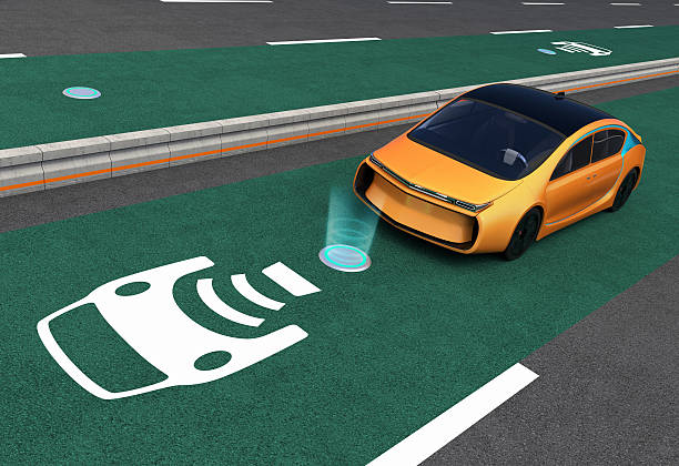 Yellow electric car on EV wireless charging lane stock photo