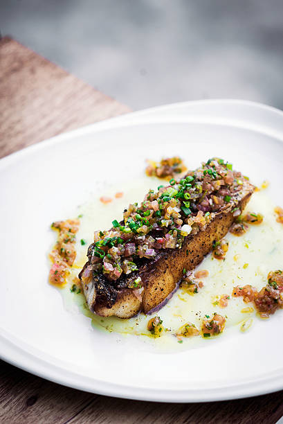 istock sea bass fish with mexican salsa sauce 520501422