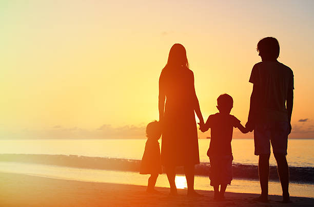 istock happy family with two kids on sunset beach 520502092