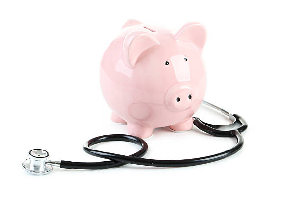 istock Pink piggy bank with stethoscope isolated on a white 520503090