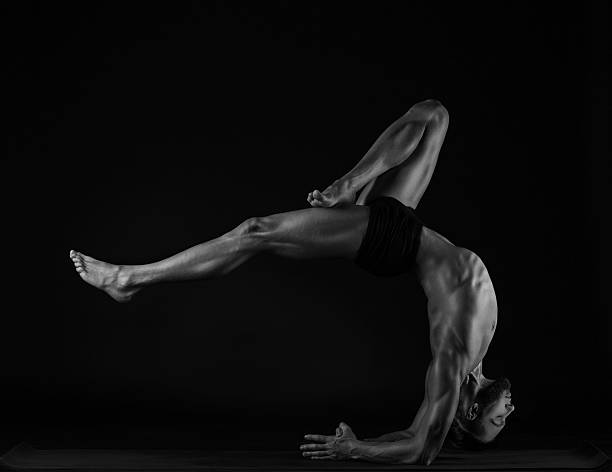 istock man practicing yoga, studio photo,black and white 520503742