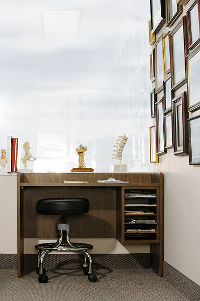 istock Doctor's desk by window, diplomas on wall 520506249