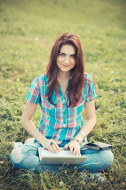 istock beautiful young hipster woman using laptop and tablet 520507865