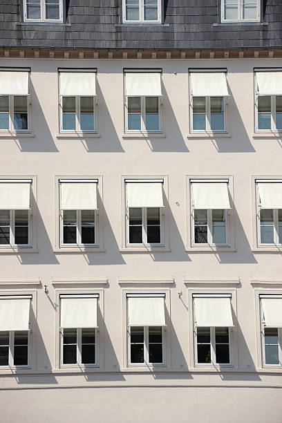 istock Facade of grey building with  white awning and shade 520509893