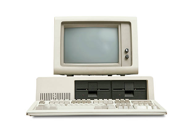 Old personal computer, eighties style, white background Vintage old personal computer from the eighties, with detached monitor and keyboard. Obsolete technology. Front low angle view, isolated on white background with clipping path. crt computer screen stock pictures, royalty-free photos & images