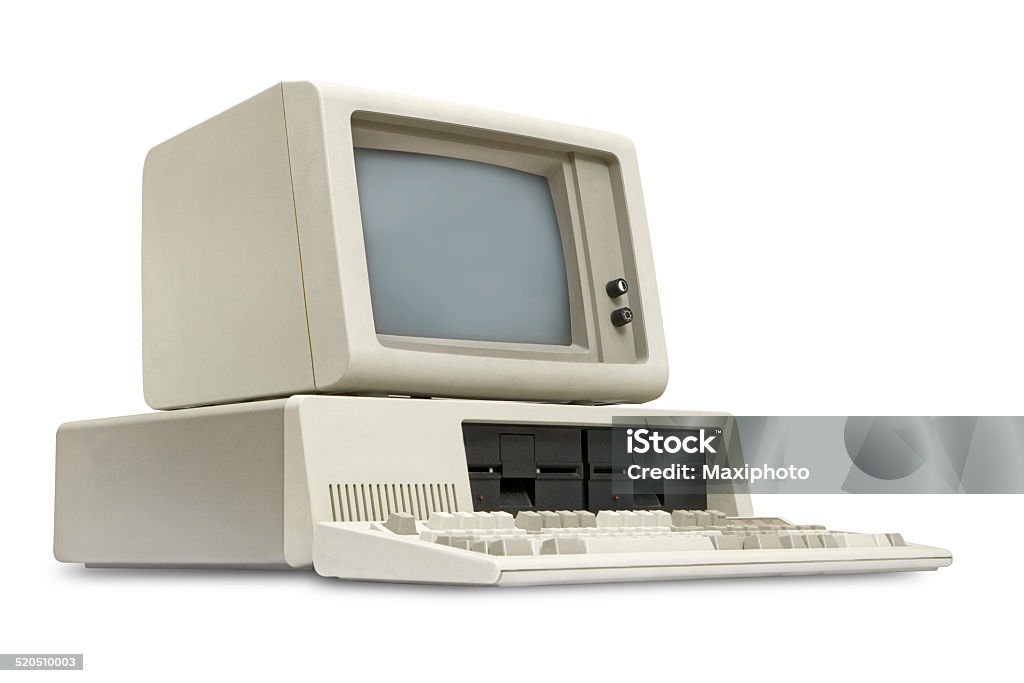 Old personal computer, eighties style, white background Vintage old personal computer from the eighties, with detached monitor and keyboard. Obsolete technology. Left side low angle view, isolated on white background with clipping path. Computer Stock Photo