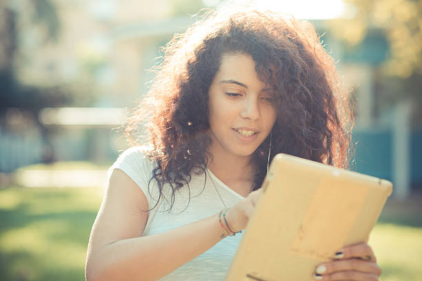 istock young beautiful moroccan curly woman using tablet 520510641