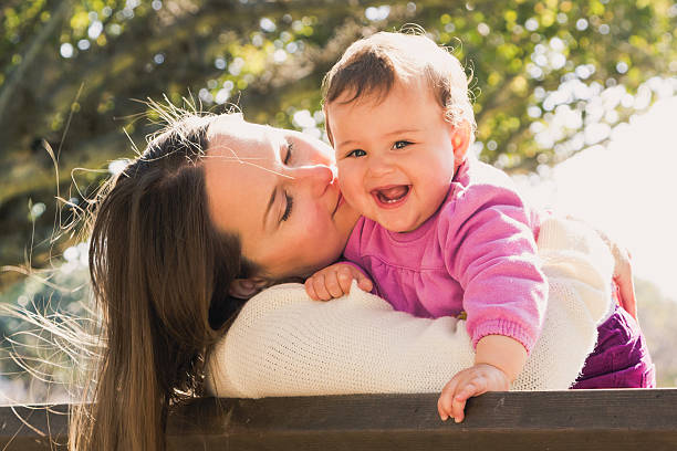 istock Happy mother and daughter are playing at a park 520511647