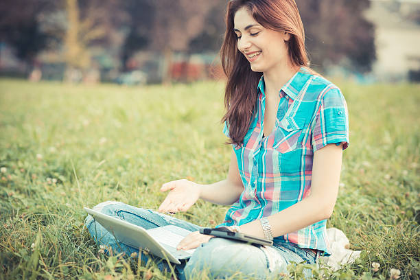 istock beautiful young hipster woman using laptop and tablet 520512089