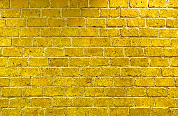 istock Vibrant yellow brick wall as a background 520513599