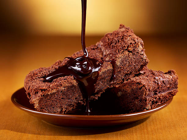 istock chocolate pouring over slices of cake 520535711