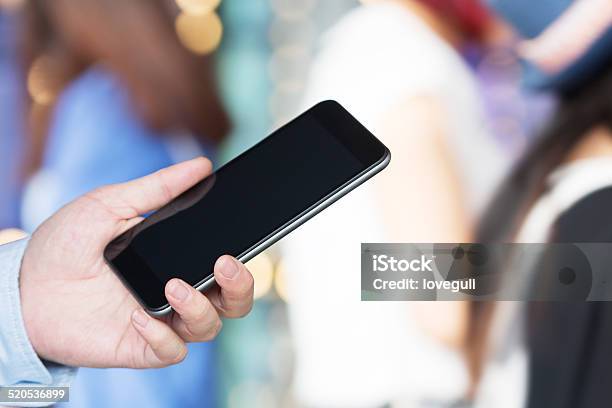 Businessman Use Mobile Phone In Illuminated Street Of Modern Cit Stock Photo - Download Image Now