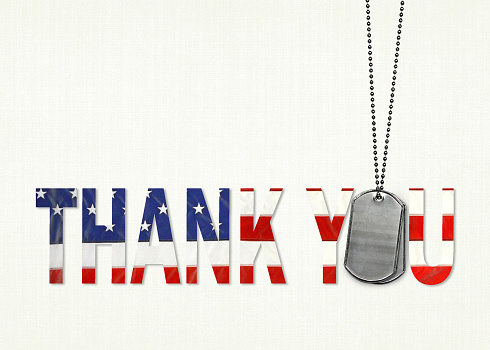 Flag thank you with military dog tags on textured background.