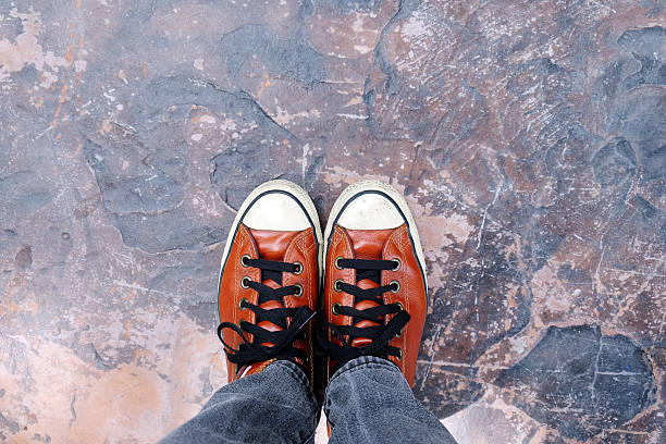 istock Feet in sneaker on concrete floor. 520538225