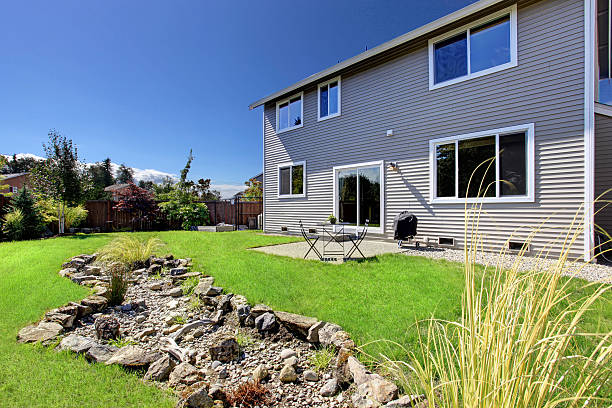 istock Beautiful backyrd landscape design with lawn and rocks 520540273