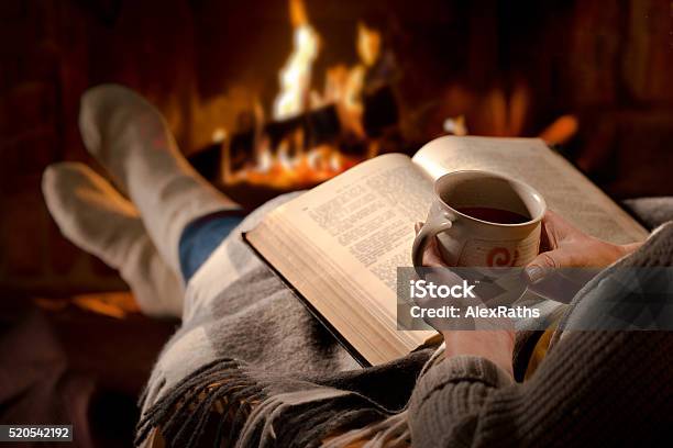 Woman Reads Book Near Fireplace Stock Photo - Download Image Now - Drinking, Fire - Natural Phenomenon, Book