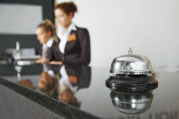 Hotel reception with bell Modern luxury hotel reception counter desk with bell motel stock pictures, royalty-free photos & images