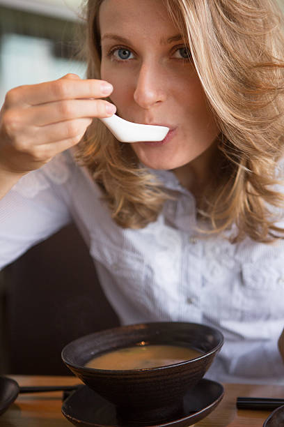 istock Woman eating soup 520542769
