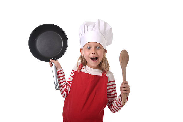 istock child in cooking hat and red apron playing mini chef 520544404