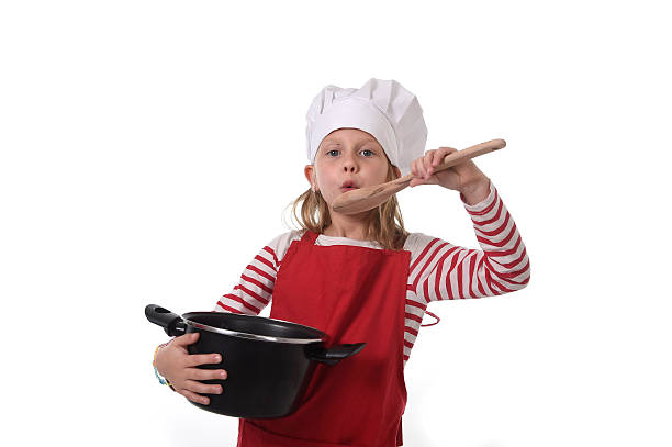 istock child in cooking hat and red apron playing mini chef 520545072