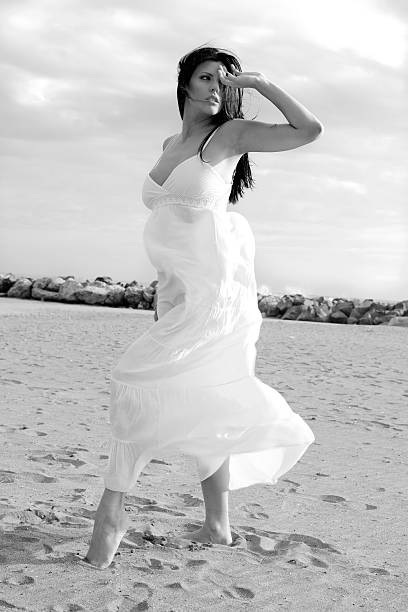istock Beautiful female dancer posing on the beach 520546210