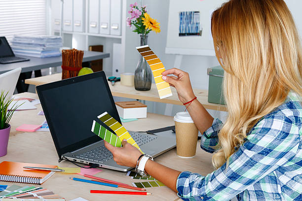 istock Hands of female designer in office working with colour samples 520548026