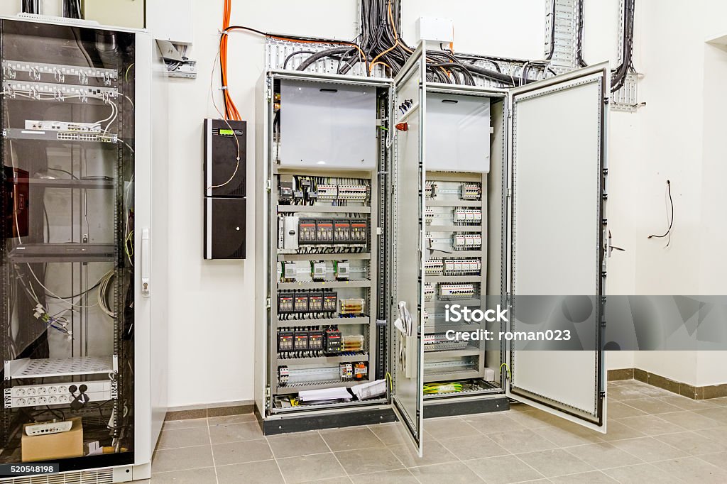 Electrical control panel in distribution fuse box. Automatic programming relay has control over electrical panel, power lines located inside of the switch box. Electricity Stock Photo