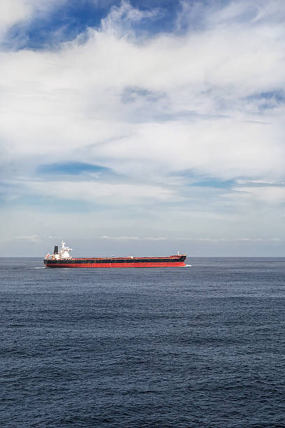 istock Vertical image of a cargo ship in the sea 520551096