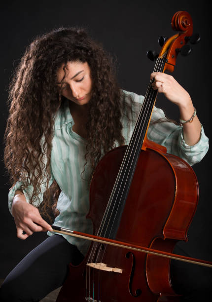 istock Young Woman Playing Cello 520552580