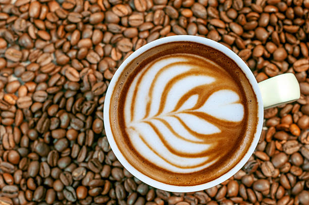 istock Coffee bean background with cup of fresh hot espresso 520553736