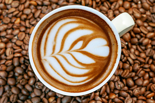 istock Coffee bean background with cup of fresh hot espresso 520553872