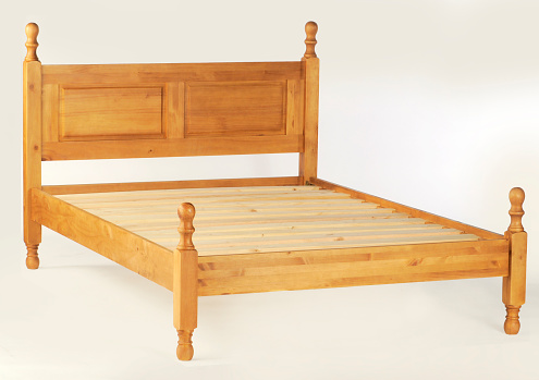 A woooden double bed frame on a white background