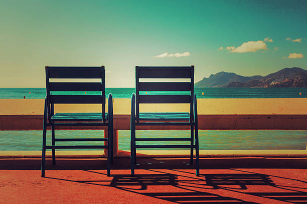 International Film Festival - French Riviera Two blue chairs on the Croisette in Cannes film festival photos stock pictures, royalty-free photos & images