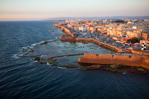 Photo from above of the southern coast of old city of Akko, Israel at sunset.