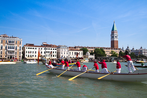 Venice, Italy - May 17, 2015: Gondoliers participate in the Festa della Sensa, an annual spring festival celebrating the symbolic marriage of Venice to the Sea. Boats and gondolas parade and race from St. Mark's Basin (pictured here) to the Lido.